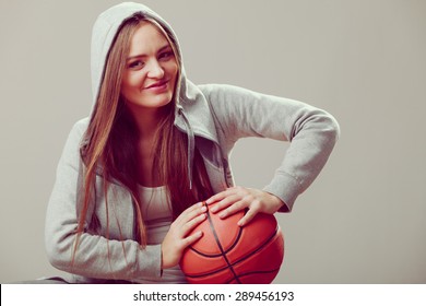 Happy Sporty Teenager Girl Wearing Hooded Sweatshirt Holding Basketball. Teen Sport. 