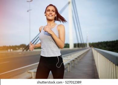 Happy Sporty Woman Jogging Outdoors