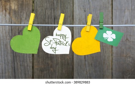 happy St Patrick's Day card, March 17, with Leprechaun hat and pot of gold, on pegs ( clothespin ) - Shutterstock ID 389829883