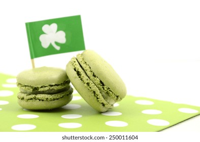 Happy St Patricks Day green macaron cookies with shamrock flag on white table. - Powered by Shutterstock