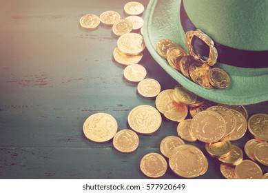 Happy St Patricks Day leprechaun hat with gold chocolate coins on vintage style green wood background,, with applied retro style faded filters. - Powered by Shutterstock