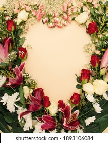 Happy St Valentine`s Day With Fresh Floral, Red, White And Pink Roses, White Chrysanthemums And Royal Lilies On Champagne Background. Heart-shaped Frame. Minimal Flat Lay.