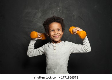 Happy Strong Black Child Boy With Dumbbells