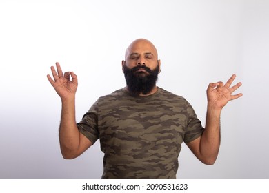 Happy Strong Healthy bald guy, doing yoga exercise meditating closed eyes make fingers mudra gesture