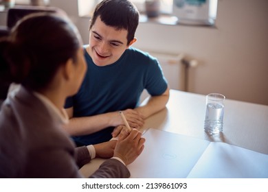 Happy Student With Down Syndrome Communicating With His Special Education Teacher While Homeschooling. 