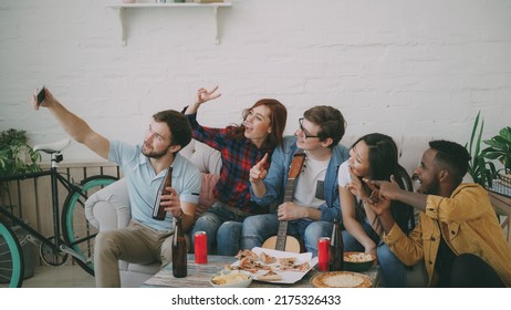 Happy Student Friends Taking Selfie And Posing While Have Party With Beer And Pizza In Shared Accommodation