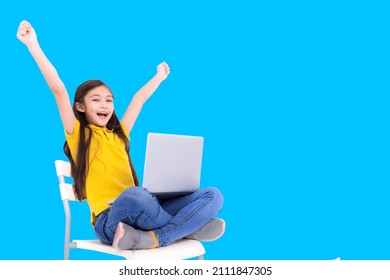 happy student girl holding laptop computer while sitting on the chair - Powered by Shutterstock