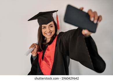 Happy Student In Graduation Cap And Gown Taking Selfie, Senior 2021