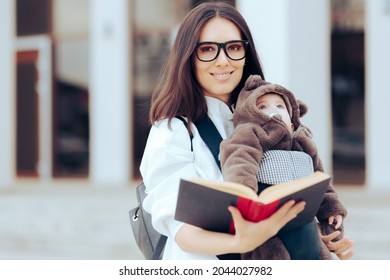 Happy Student Mom Holding A Book And Baby In Sling. Mother Continuing Her Education Going To School With Baby In Carrier
