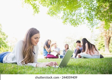 Happy Student Using Her Laptop Outside At The University