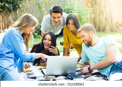 Happy Student Using Laptop In Campus