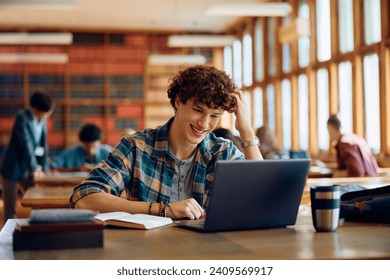 Happy student using laptop while learning during a class at high school.  - Powered by Shutterstock