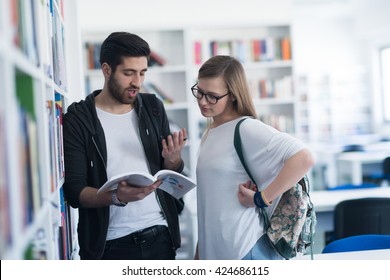 Happy Students Couple In School  Library Have Discussion About Book