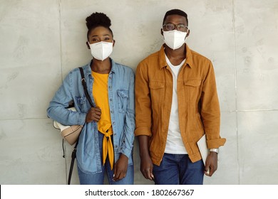 Happy Students With Face Masks Against The Wall And College Hallway. 