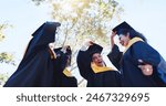 Happy students, graduation and celebration with hat in nature for achievement, success or milestone. Group of excited graduates or friends with smile in happiness for scholarship or higher education