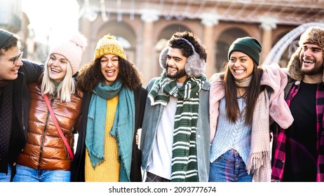 Happy Students Group Walking At European City On Sunny Day - Next Gen Life Style Concept With Multiracial Young People Wearing Winter Fashion Clothes Having Fun Together Outdoors - Backlight Filter