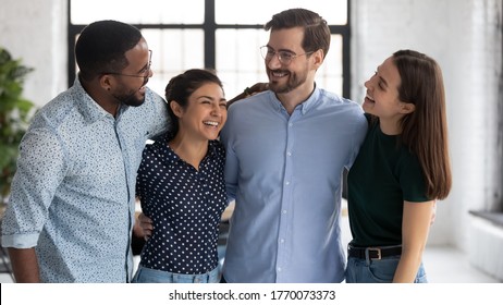 Happy Students Pass Exams Successfully Gather Together Celebrating. Corporate Staff Members Having Warm Friendly Relations Hugging Chatting Enjoy Funny Conversation. Racial Equality Friendship Concept