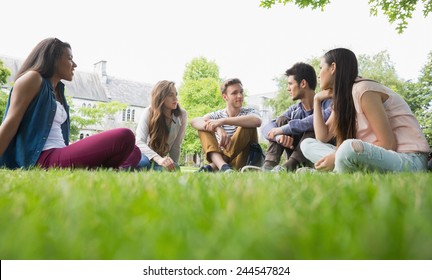 Happy Students Sitting Outside On Campus At The University