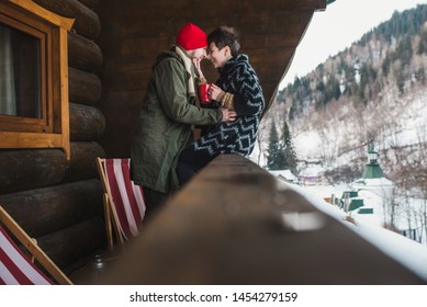 Happy Stylish Couple Have Fun On The Wooden Chalet Terrace Outdo