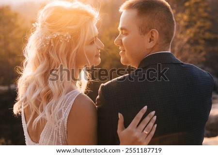 Similar – Image, Stock Photo Happy stylish couple newlyweds in the green forest on summer day. bride in long white dress and groom in red suit are hugging. wedding day