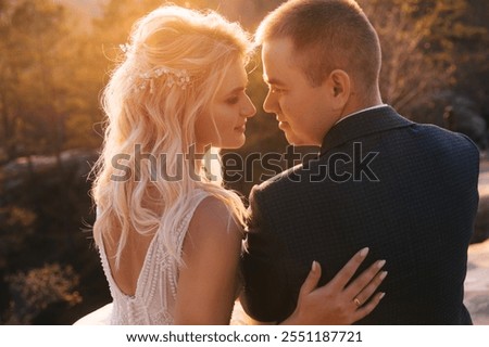 Similar – Image, Stock Photo Happy stylish couple newlyweds in the green forest on summer day. bride in long white dress and groom in red suit are hugging. wedding day