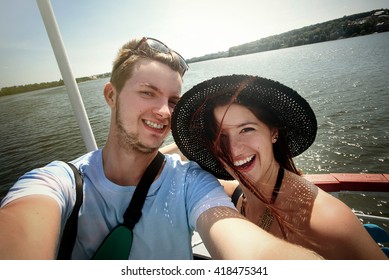 Happy Stylish Couple Taking Selfie And Sailing On A Boat, Having Fun, Summer Vacation. Wanderlust