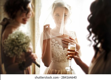 happy stylish gorgeous blonde bride with bridesmaids on the background  hotel room - Powered by Shutterstock