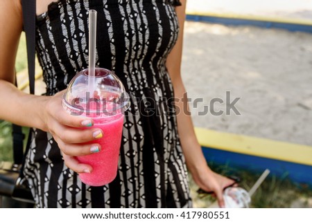 happy stylish woman hipster holding colorful pink cocktail in hand, summer travel concept, space for text