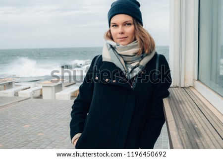 Similar – Woman walking on a beach on a cloudy day