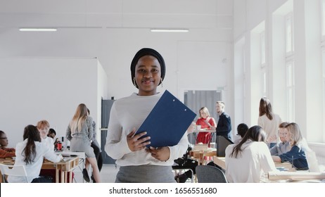 Happy Successful African Female Manager In Head Scarf Walking At Modern Office Smiling At Camera Slow Motion RED EPIC.