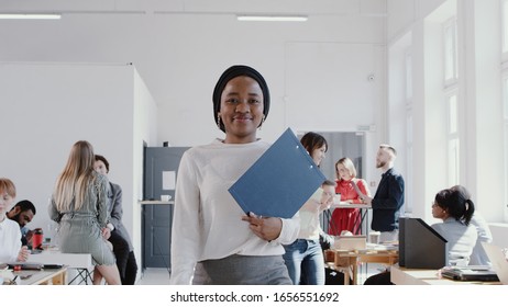 Happy Successful African Female Manager In Head Scarf Walking At Modern Office Smiling At Camera Slow Motion RED EPIC.