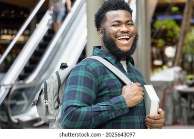happy and successful African male college student getting back to school - Shutterstock ID 2025643097