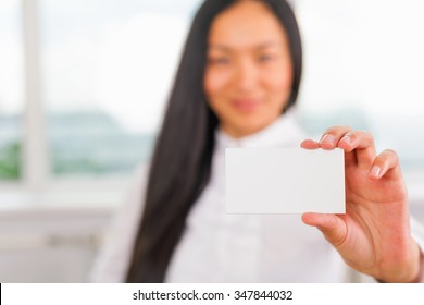 Happy And Successful Asian Businesswoman Gives You A Business Card Or Visiting Card With A White Background On A Blank For Copy Space And Any Contacts Or Phone Number