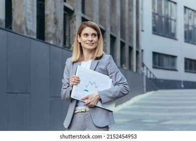 Happy And Successful Business Woman With Laptop And Documents Outside Office Smiling In Business Suit