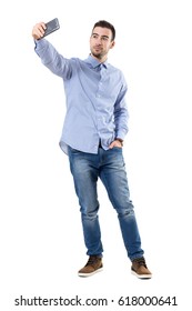 Happy Successful Businessman Taking Selfie Looking At Smart Phone. Full Body Length Portrait Isolated Over White Background.