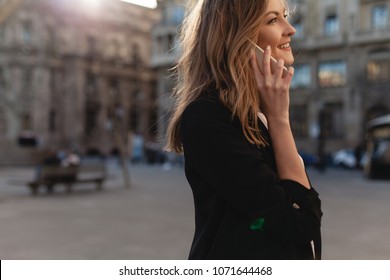 Happy Successful Businesswoman Calling With Cell Telephone Outside, Smiling Female Entrepreneur Managing Business Talking Via Mobile Phone And Walking On The City Street,  Making Phone Call After Job 