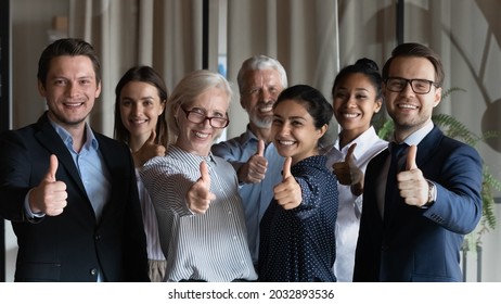 Happy successful diverse businesspeople employees group showing thumbs up together, looking at camera, standing in office, excited colleagues team recommending best corporate service, good career - Powered by Shutterstock