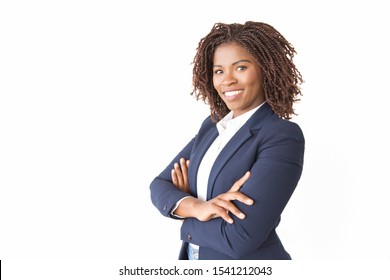Happy successful female professional smiling at camera. Young African American business woman with arms crossed standing isolated over white background. Confident businesswoman concept