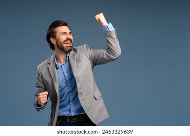 Happy successful gesturing businessman, isolated on blue background, celebrating. Copy space. Success, career, business concept - Powered by Shutterstock