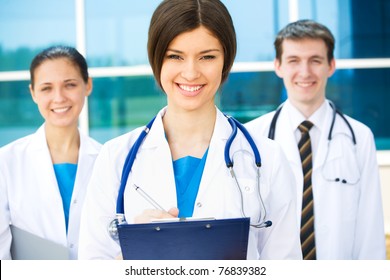 A Happy And Successful Medical Team Outside Hospital Building