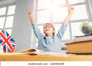 Happy Successful Schoolboy Raises Hands Up In Wide Classroom, Successful Learning English Language