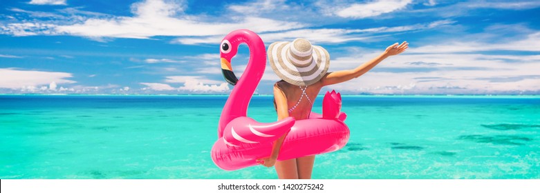 Happy summer vacation fun woman tourist enjoying travel holidays on beach banner background ready for swimming pool with flamingo float - funny holiday concept.