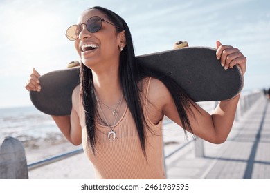 Happy, summer and woman by ocean with skateboard for weekend, holiday and vacation in trendy style. Fashion, laughing and person skateboarding for activity, freedom and adventure by broadwalk seaside - Powered by Shutterstock