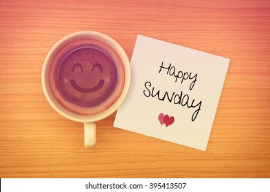 Happy Sunday on paper note with coffee cup,top view.