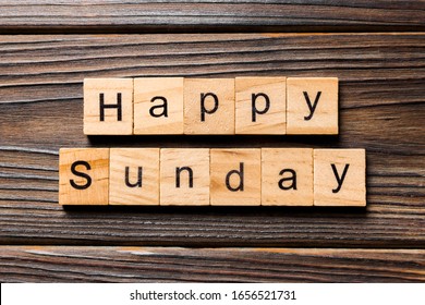 Happy sunday word written on wood block. Happy sunday text on wooden table for your desing, concept.