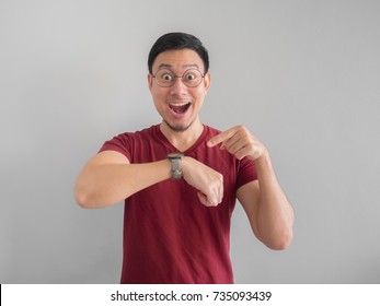 Happy And Surprised Asian Man Who Is Looking At His Watch.