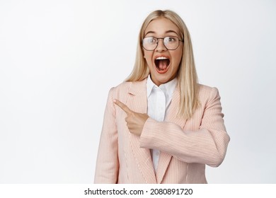 Happy And Surprised Business Woman Pointing Left, Scream From Excitement, Showing Advertisement, White Background