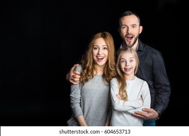 Happy Surprised Family Standing Together Isolated On Black