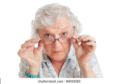 Happy surprised old senior lady looking through her eyeglasses isolated on white background