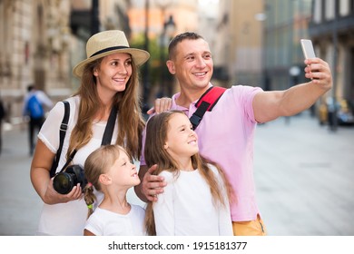 Happy Swedish Family Of Tourists Making Selfie During Travelling On European City